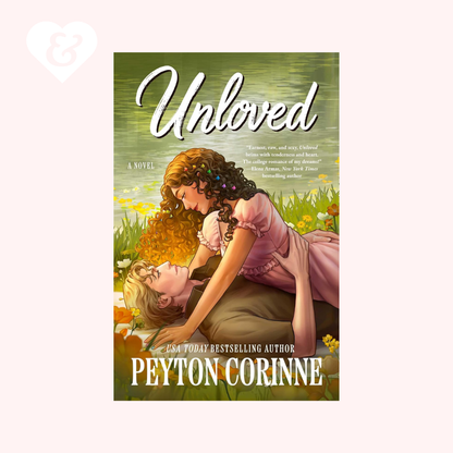 Book cover for the novel 'Unloved' by Peyton Corinne, featuring an illustrated scene of two women embracing in a grassy field with yellow flowers. The cover is centered on a pale pink background with a faint white heart-and-key graphic in the upper left.
