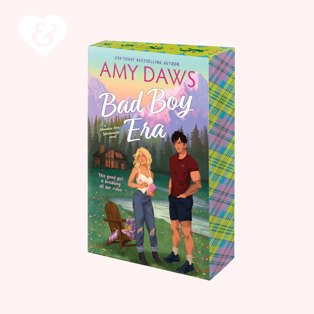Book box for 'Bad Boy Era' by Amy Daws, featuring colorful illustrated cover art with a couple, a cabin, and a plaid pattern on the side, shown on a pale pink background.
