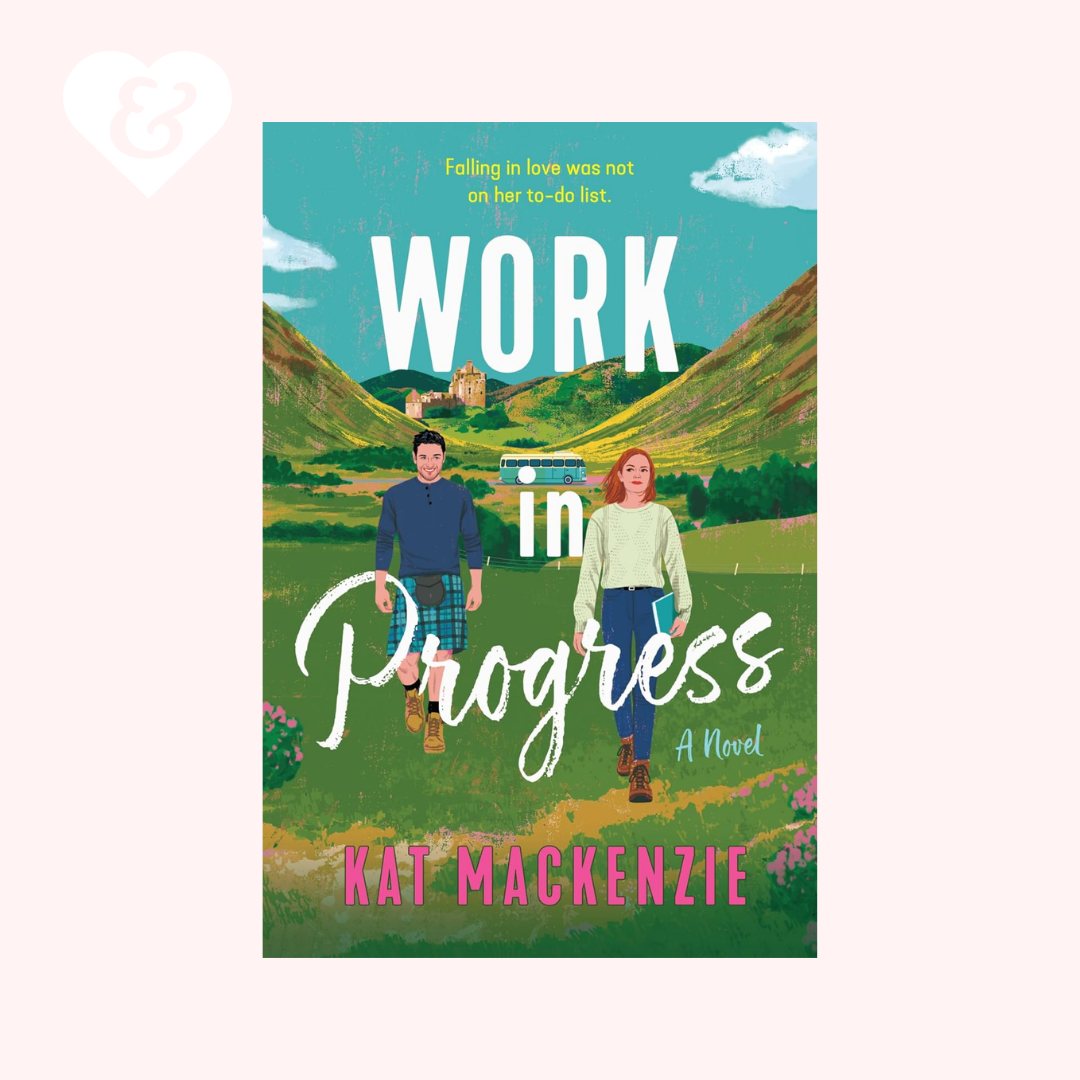 Book cover for the novel 'Work in Progress' by Kat Mackenzie, featuring an illustrated couple walking through a green valley with mountains and a blue sky. The title is displayed prominently in white, with the author's name in pink at the bottom.