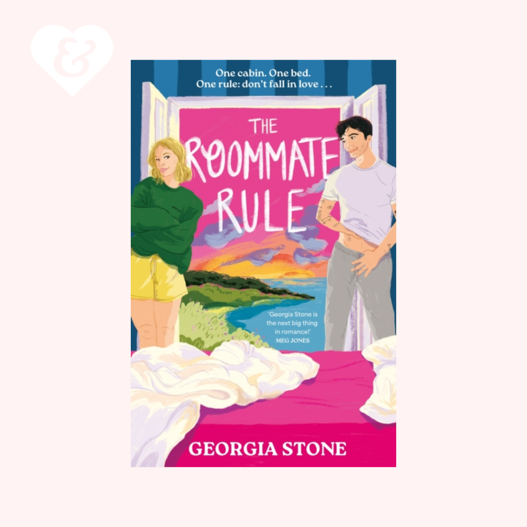 Book cover for 'The Roommate Rule' by Georgia Stone, featuring an illustrated couple in a bedroom with a pink and blue sunset background, shown on a pale pink background with a small white heart-and-key icon in the top left.