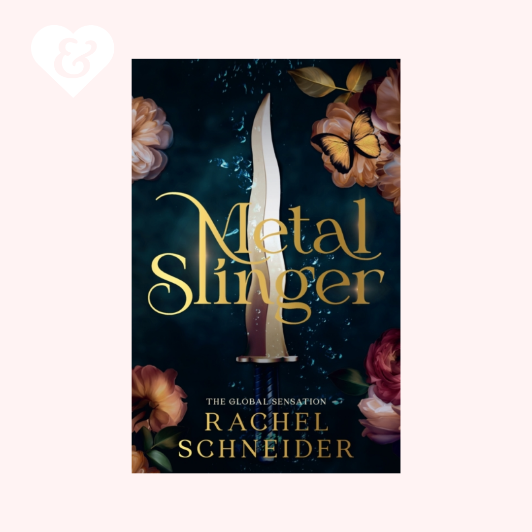 Book cover for 'Metal Slinger' by Rachel Schneider, featuring a vertical dagger with a silver blade and a purple handle against a dark blue background with gold lettering, surrounded by roses and a butterfly. The book is centered on a pale pink background with a small white heart-and-key icon in the top-left corner.