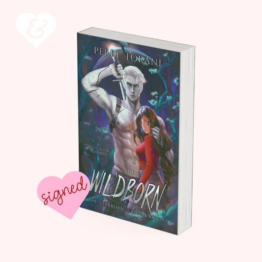 The book cover of 'The Wildborn' by Perri Torani, featuring a muscular pale blonde man holding a sword and a woman in a red dress, set against a dark blue and purple background. The book is displayed on a light pink background with a pink 'signed' heart graphic and a white heart logo in the corners.