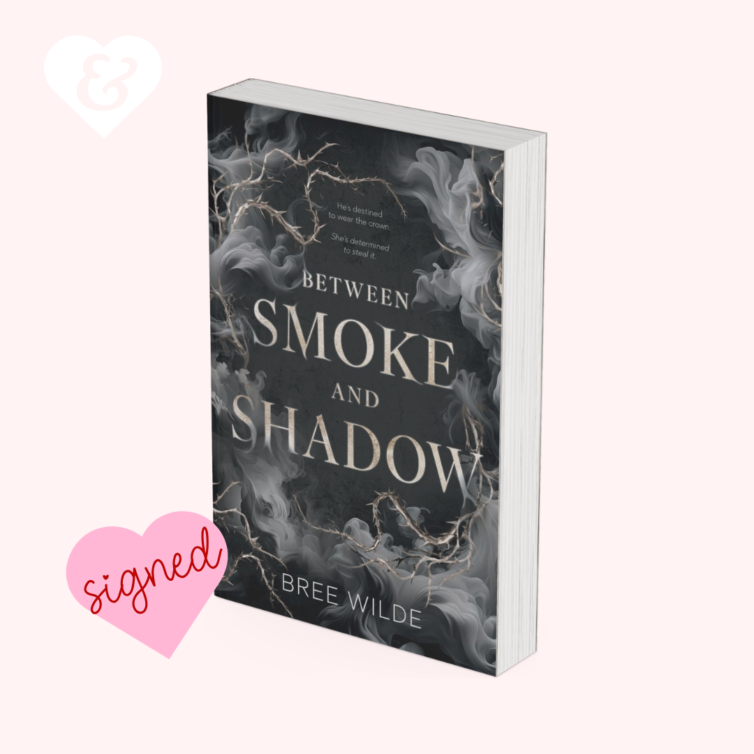 The book "between smoke and shadow" by bree wilde with a smoky black design with a heart that says "signed"