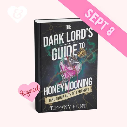 A signed copy of the book 'The Dark Lord's Guide to Honeymooning' by Tiffany Hunt, displayed on a light pink background with decorative heart graphics and a pink 'SEPT 8' banner overlay.