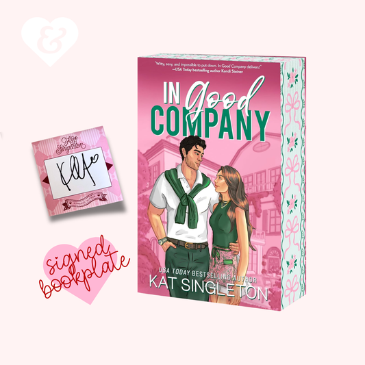 Book box for 'In Good Company' by Kat Singleton, shown with a signed bookplate on a pale pink background. The box features a pink cover with illustrated couple and floral-patterned side panels.