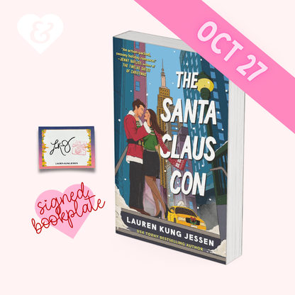 Book cover for 'The Santa Claus Con' by Lauren Kung Jessen, shown as a product mockup on a light pink background with a pink 'OCT 27' banner, a signed bookplate, and a small autograph card.