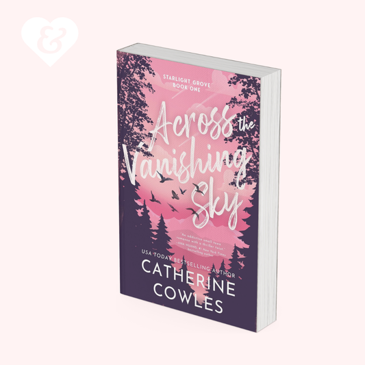 A paperback book titled 'Across the Vanishing Sky' by Catherine Cowles, displayed at an angle on a pale pink background. The cover features a purple and pink forest design with white script text.