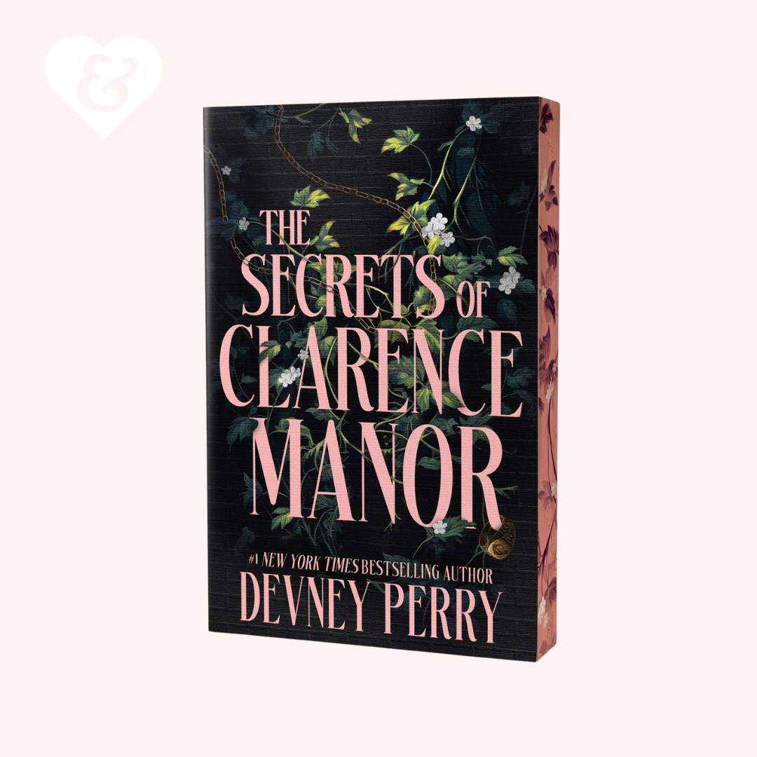 The book cover of 'The Secrets of Clarence Manor' by Devney Perry, featuring a dark background with pink lettering and green floral vines, shown on a light pink background.