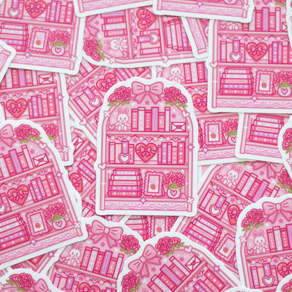 Pink illustrated bookshelves with hearts and flowers on a white background