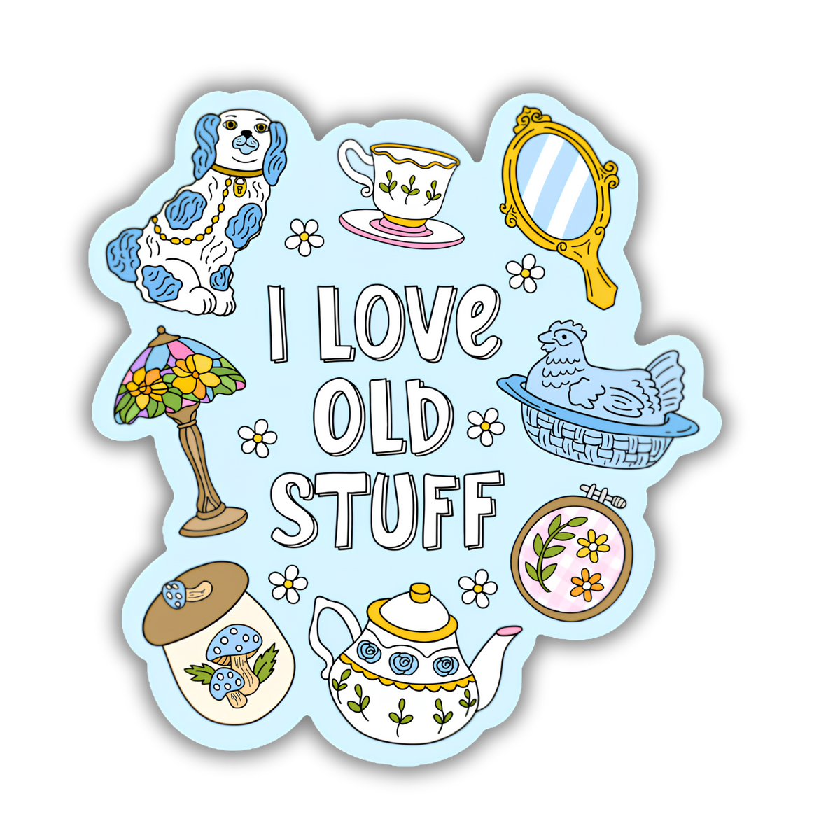 A die-cut sticker featuring a light blue background with the phrase 'I LOVE OLD STUFF' in white outlined letters, surrounded by hand-drawn illustrations including a blue-and-white dog, teacup, mirror, flower lamp, chicken basket, teapot, embroidery hoop, jar, and small flowers.