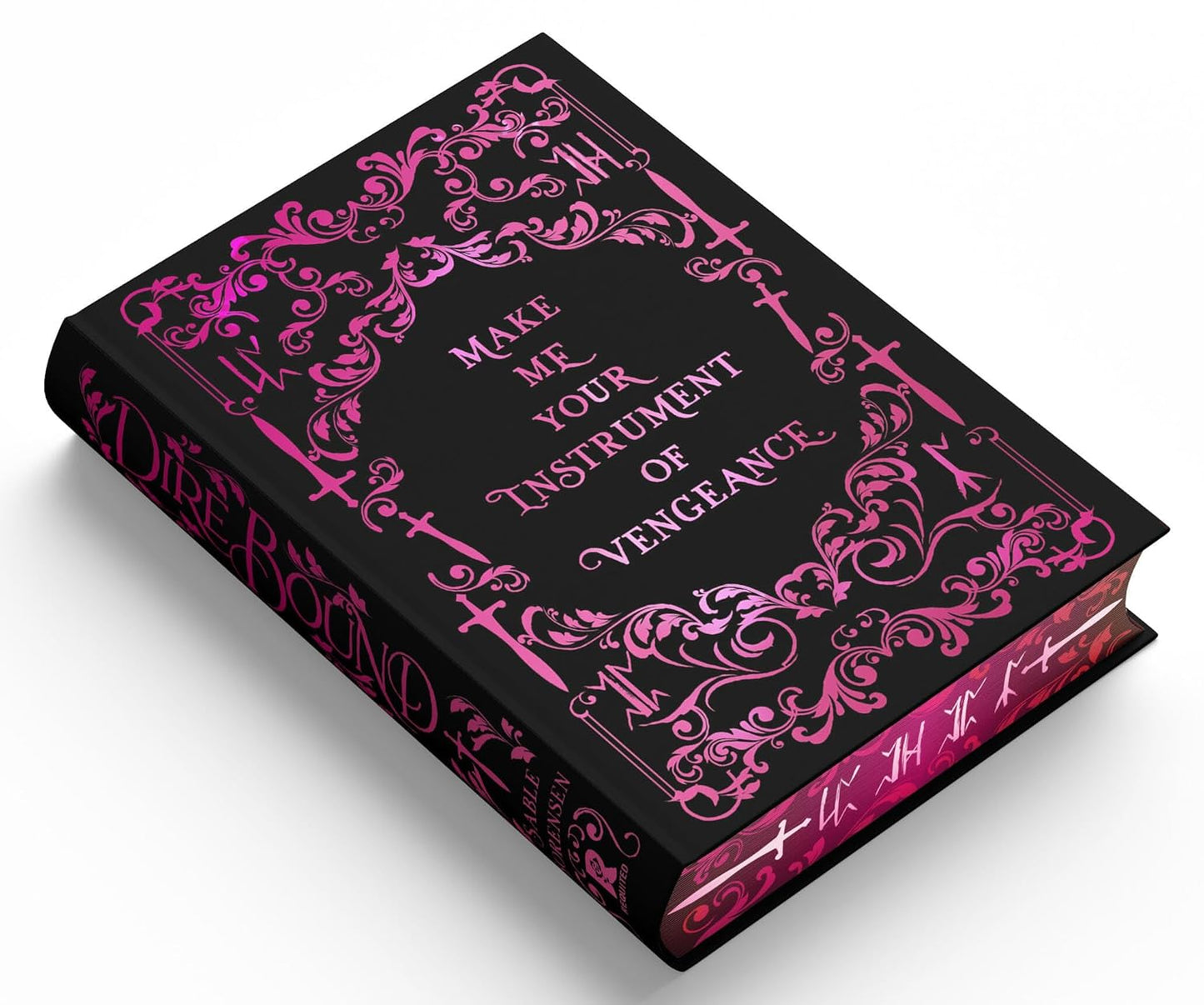 Book with ornate pink designs and text on a black background