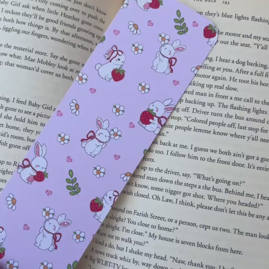 A bookmark shown from different angles in front of a book.