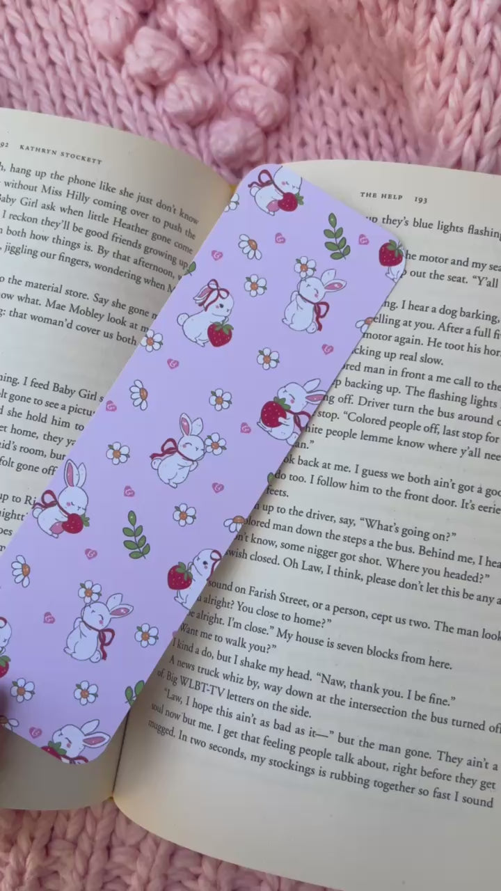 A bookmark shown from different angles in front of a book.