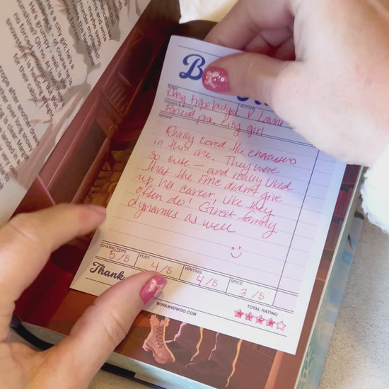 Writing in a book review tablet and putting it in a book.