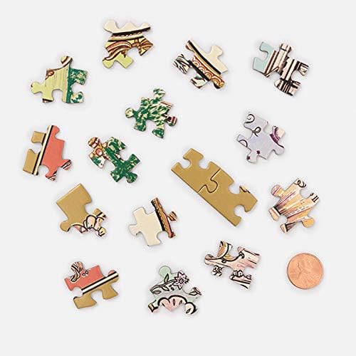 A set of small decorative jigsaw puzzle pieces scattered on a light gray background, with a copper penny shown for scale. The pieces feature various illustrated patterns and colors including green, pink, gold, white, and brown.