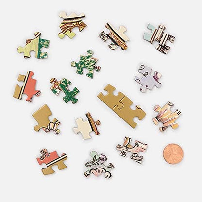 A set of small decorative jigsaw puzzle pieces scattered on a light gray background, with a copper penny shown for scale. The pieces feature various illustrated patterns and colors including green, pink, gold, white, and brown.