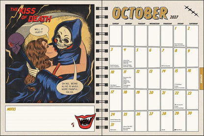 An open spiral-bound planner or desk calendar showing October 2027. The left page features a comic-style illustration of a hooded figure kissing a woman, with the title 'The Kiss of Death.